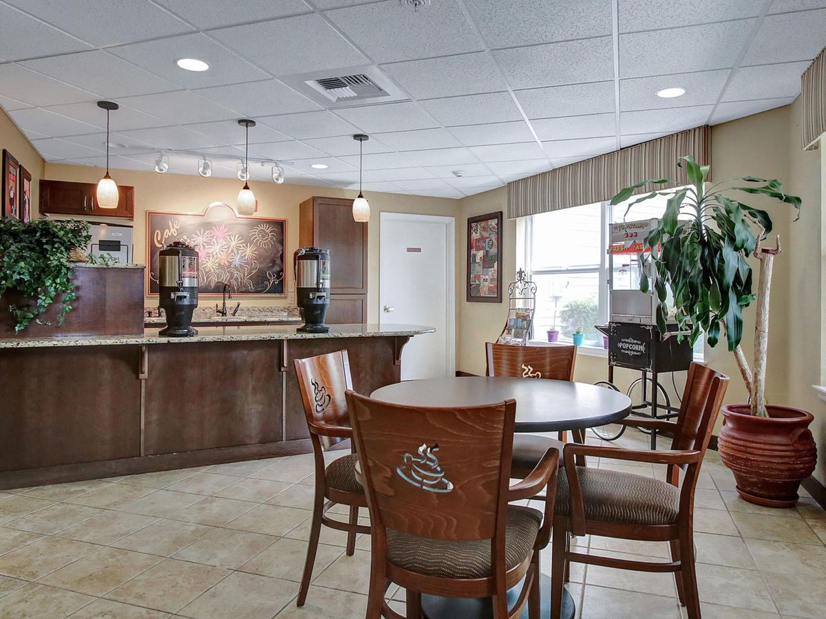 A cozy lobby with seating and a coffee station.