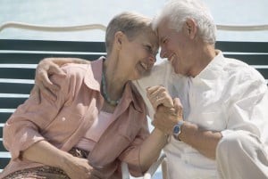 An elderly couple sharing a joyful and affectionate moment.