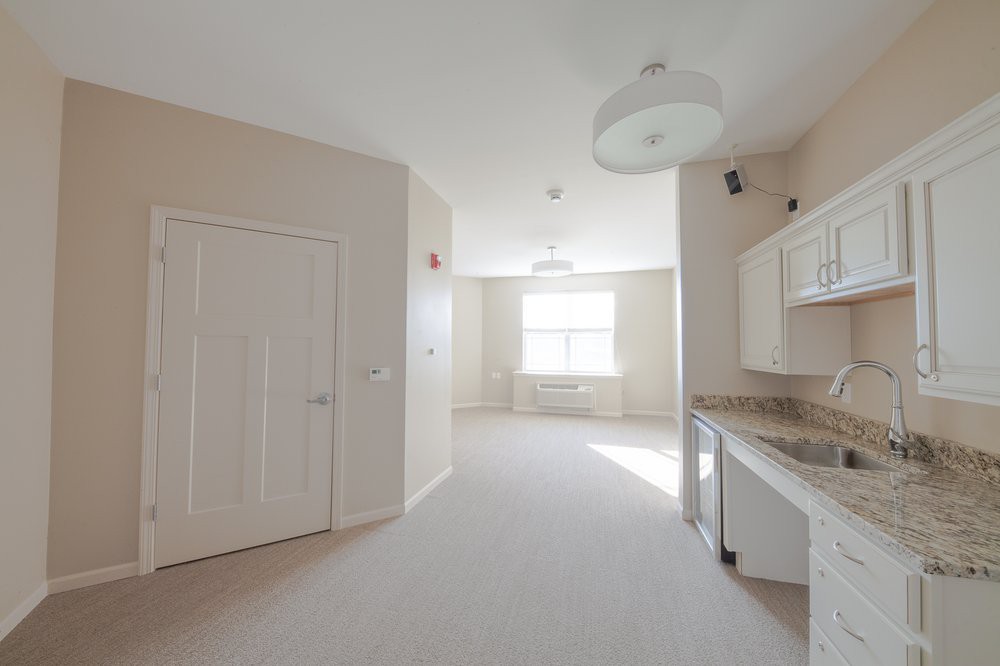 A bright and empty minimalist kitchen and living space.