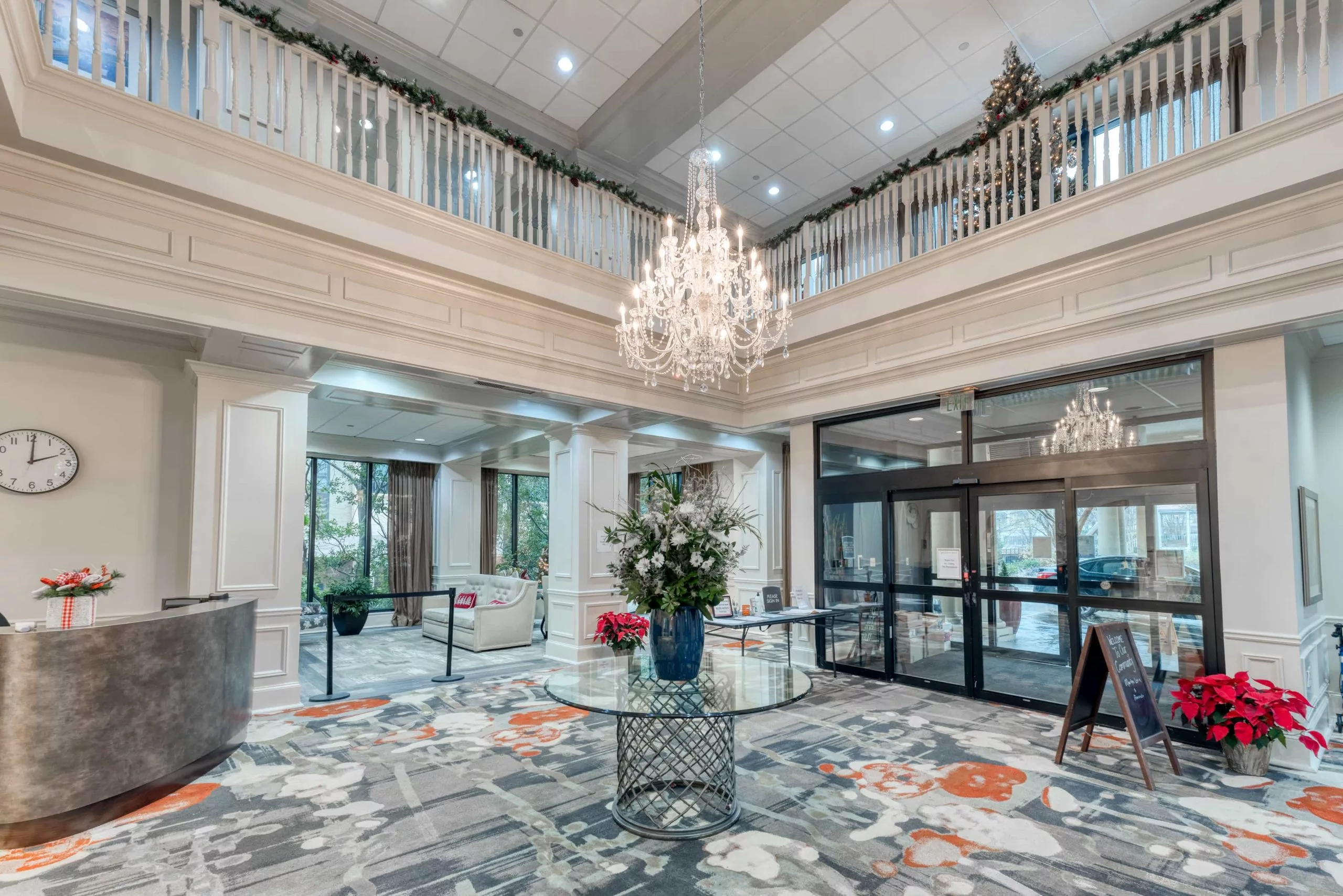 A luxurious hotel lobby with a grand chandelier and elegant decor.
