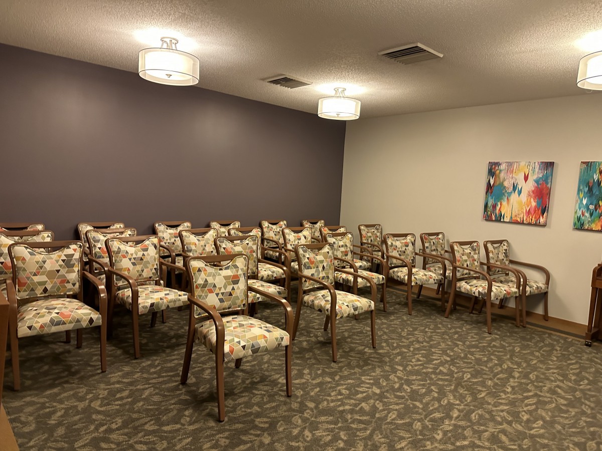 An empty conference room with neatly arranged chairs.