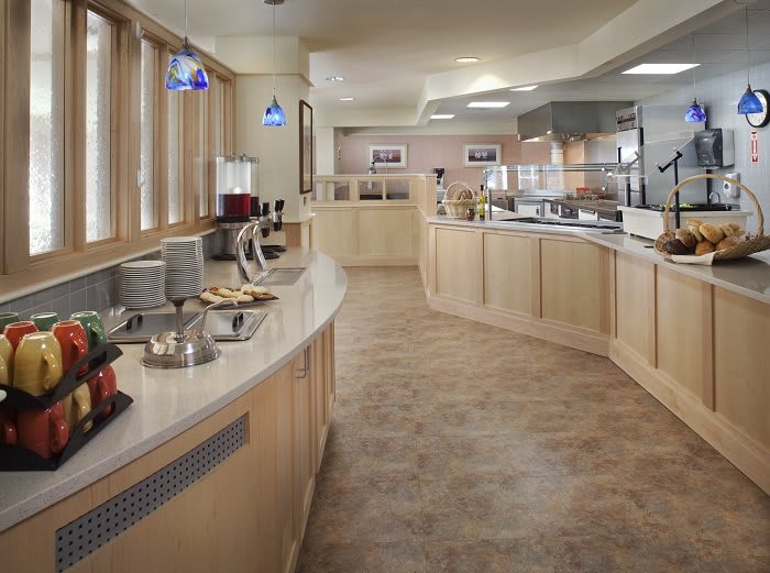 A spacious buffet area with multiple counters in a restaurant setting.