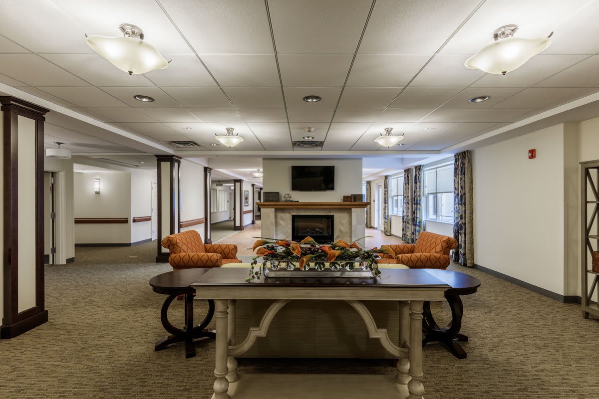 A welcoming lobby with comfortable seating and a central fireplace.
