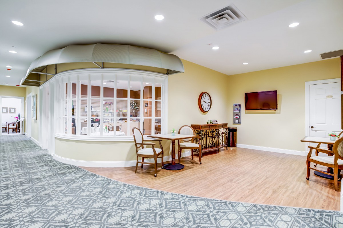 A cozy reception area with seating and a clock on the wall.