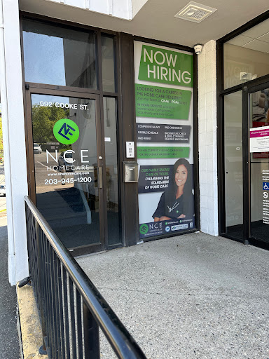A storefront with a hiring sign displayed prominently, indicating job opportunities.