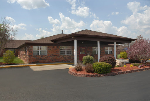 A beautifully landscaped brick building with a welcoming entrance.