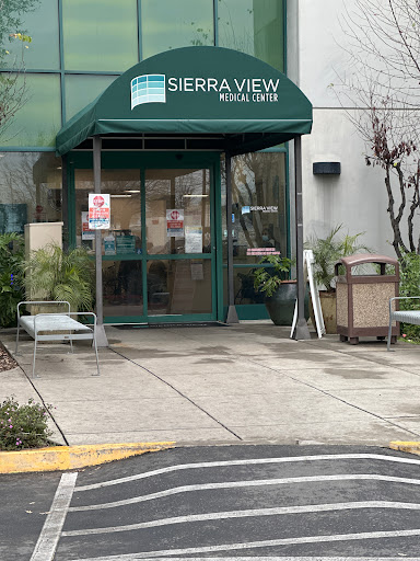 Entrance of the Sierra View building with a welcoming green awning.