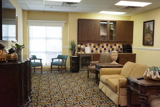 A cozy waiting room featuring comfortable seating and a bright window.