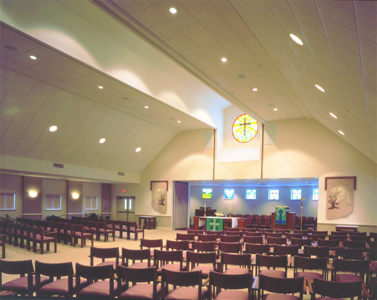 Interior view of a church with rows of seating facing the altar.