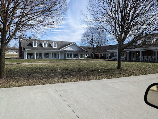 A spacious residential property with a well-maintained front yard and clear blue skies.