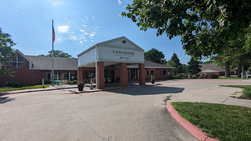 A welcoming entrance to a community facility surrounded by greenery.