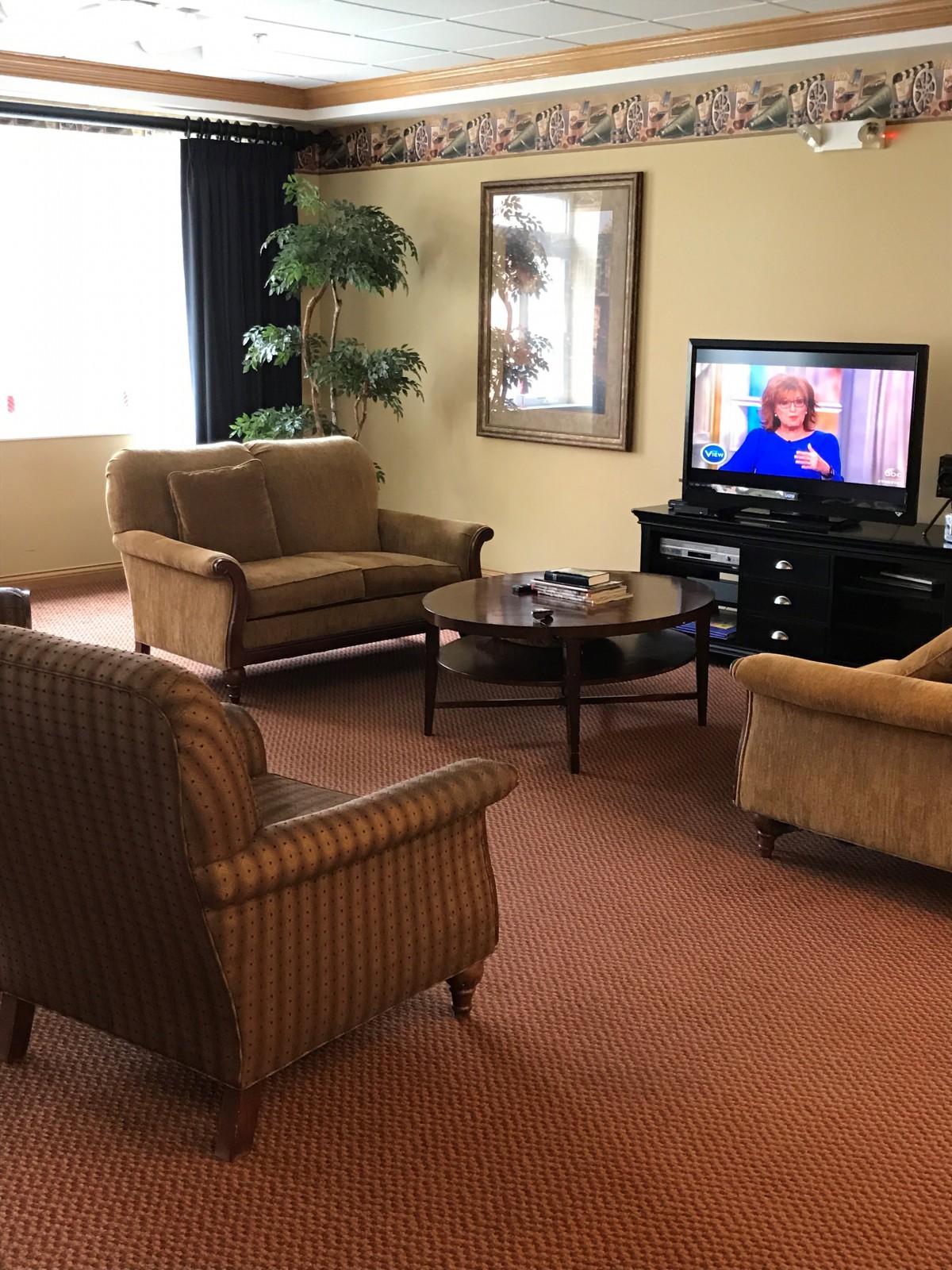 A cozy living room with comfortable seating and a television.