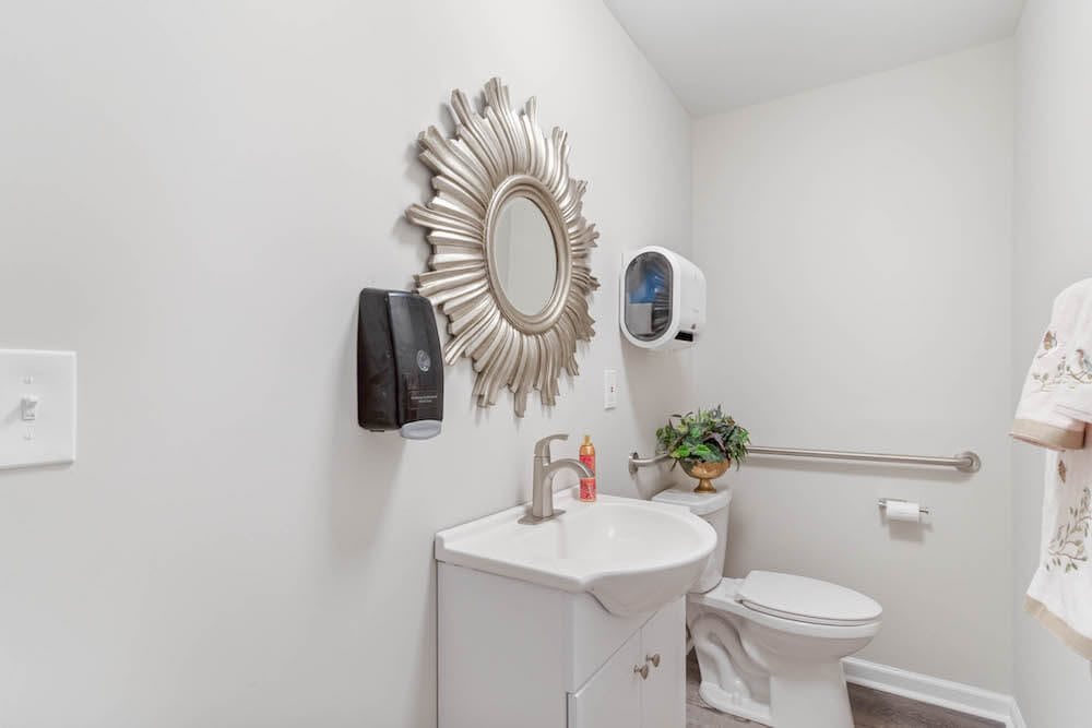 A clean and modern bathroom with decorative elements.
