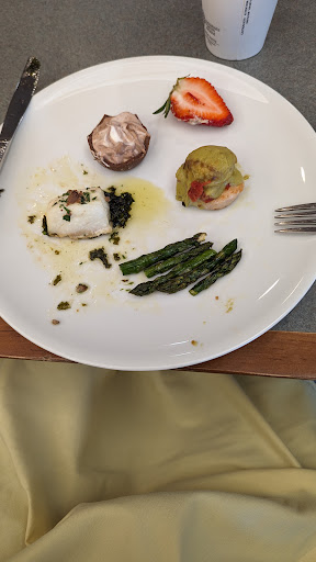 A beautifully plated dish featuring fish, asparagus, and various garnishes.