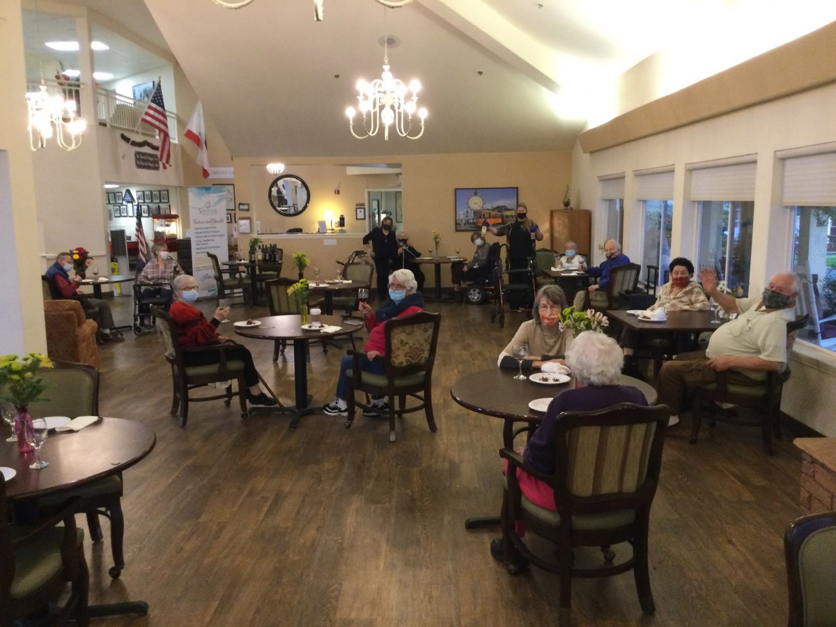 A cozy dining area with people socializing around tables.