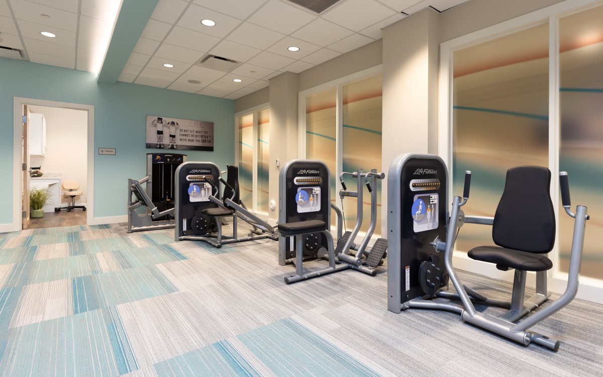 A modern gym with various exercise machines.