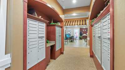 A hallway with mailboxes in an office lobby setting.