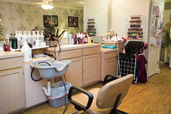 A beauty salon interior with hair styling stations and a variety of haircare products.