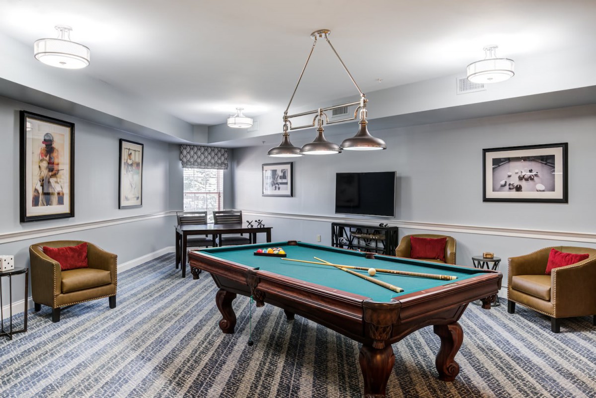 A well-furnished game room featuring a pool table and stylish decor.
