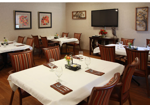 A cozy dining area set up for guests, featuring elegant tables and chairs.