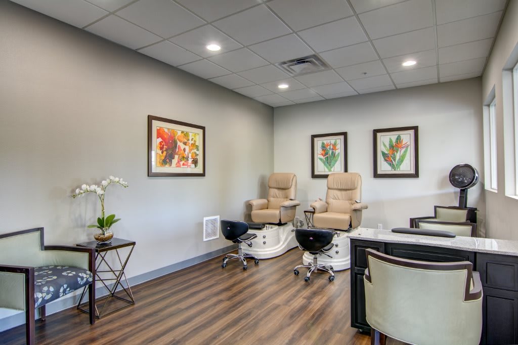A modern nail salon with comfortable pedicure chairs and elegant decor.