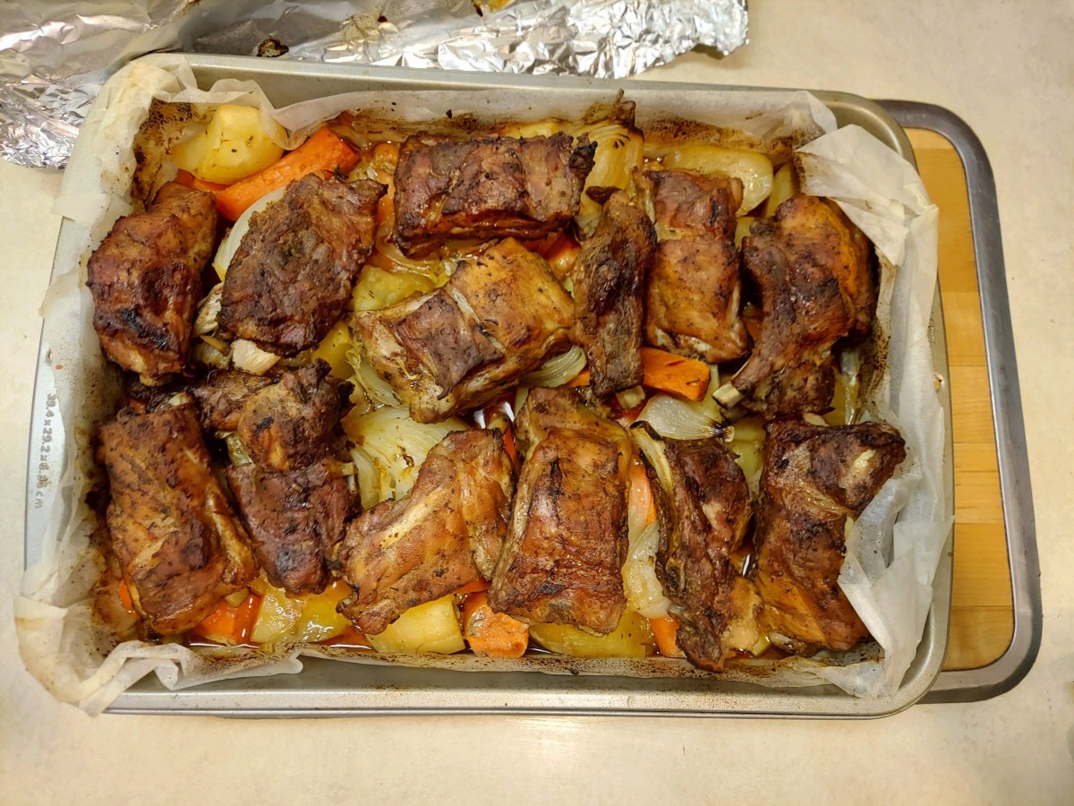 A baking dish filled with roasted meat and vegetables.