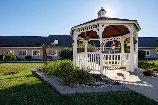 A charming gazebo surrounded by well-maintained landscaping, basking in the warm sunlight.