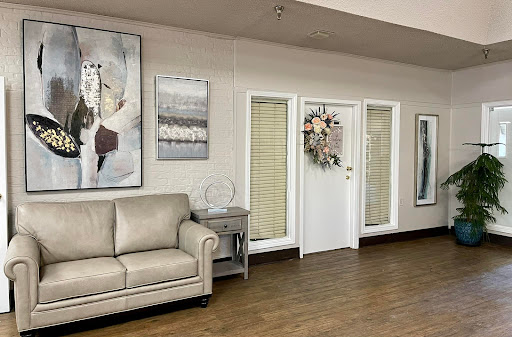 A cozy living room featuring a stylish sofa and elegant wall art.