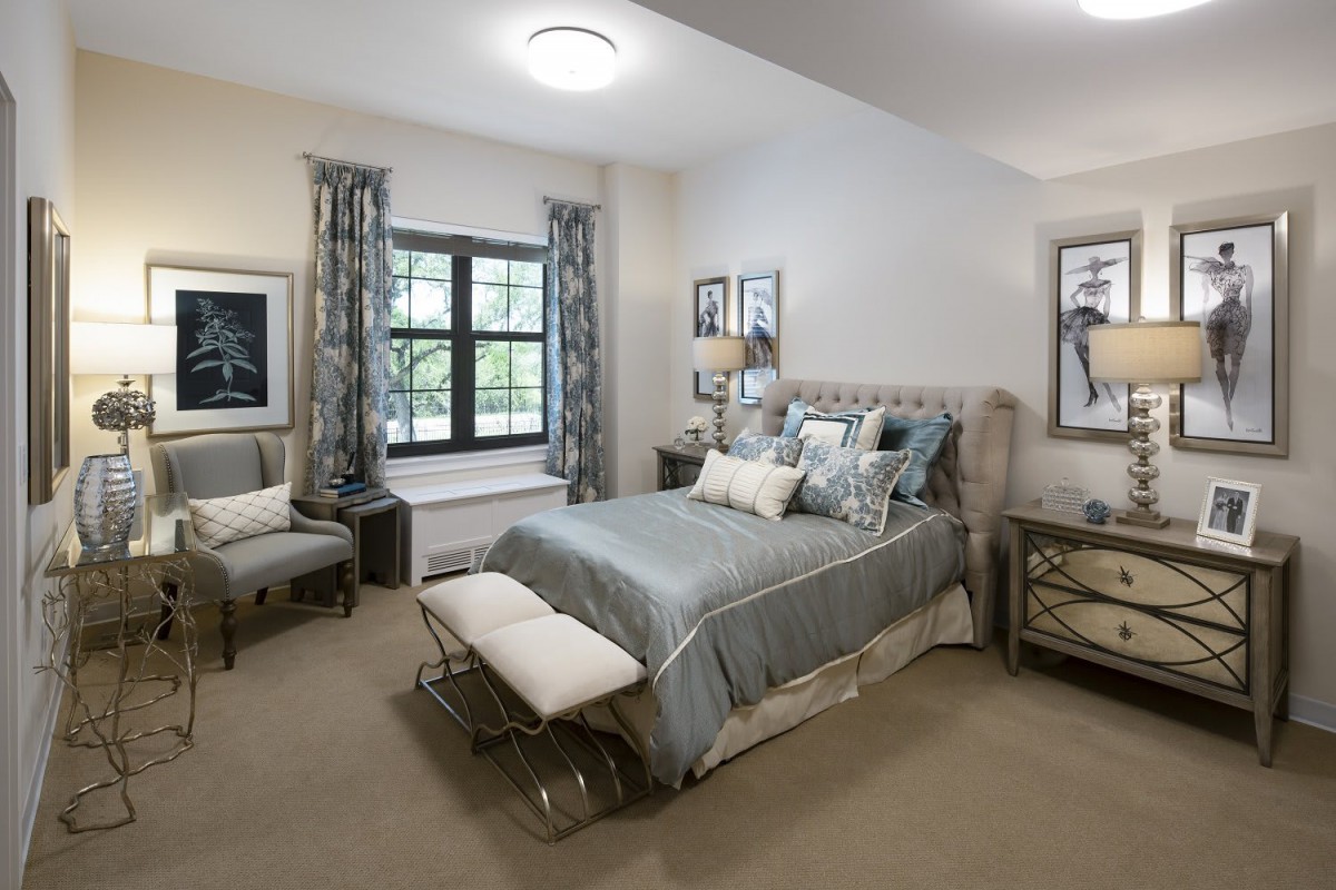 A modern bedroom with stylish decor and neutral color tones.