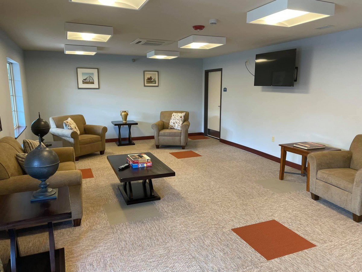 A cozy waiting room with comfortable chairs and a television.