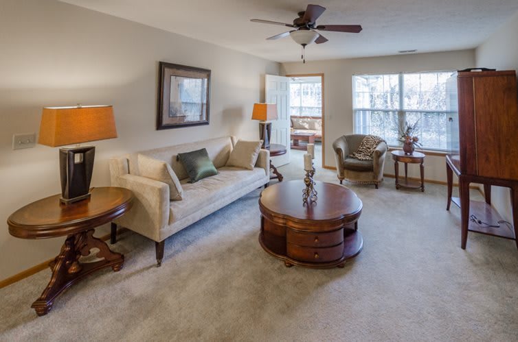 A cozy living room featuring a comfortable sofa, coffee table, and warm lighting.