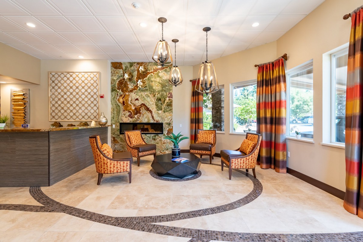 A stylish living room with modern seating, a fireplace, and decorative lighting.