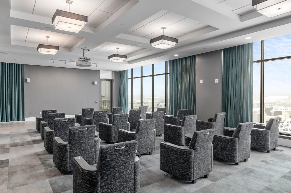 A modern conference room with comfortable seating and large windows.