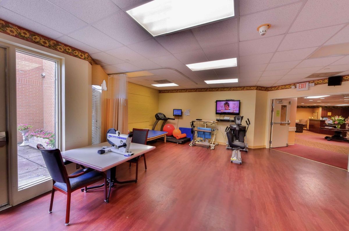 A spacious office area with tables, chairs, and various equipment.