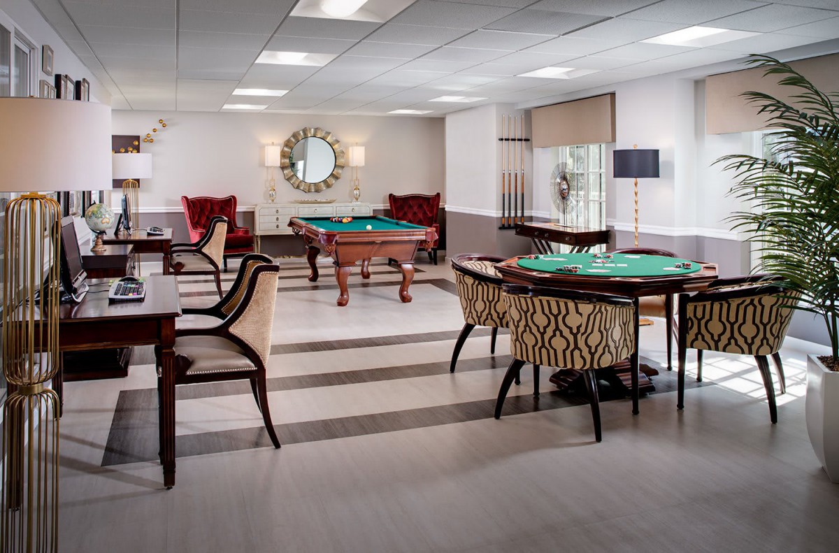 A stylish indoor game room featuring billiards tables and comfortable seating.