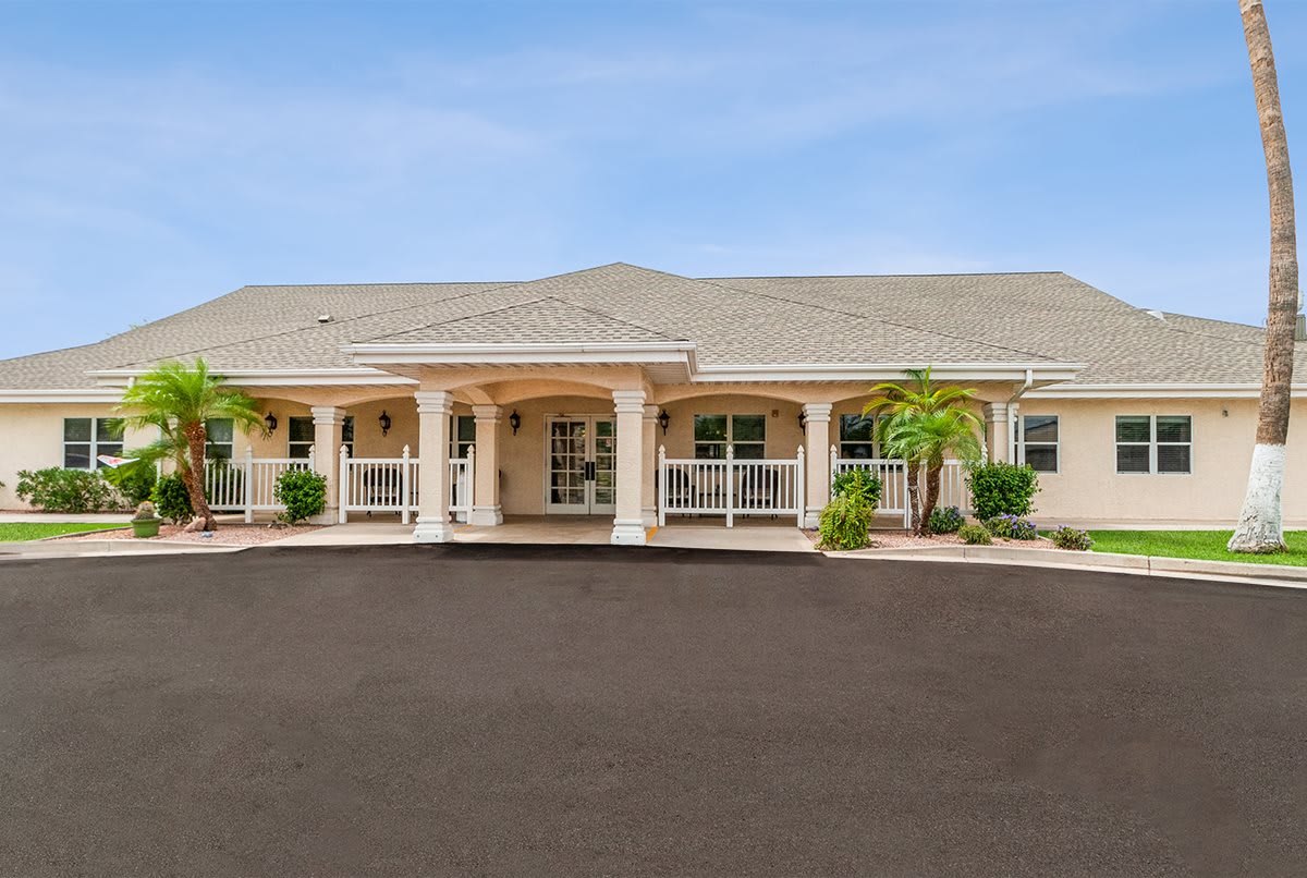 A suburban house with a large driveway and front porch.
