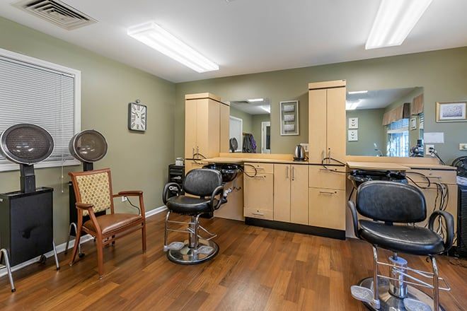 A well-organized hair salon with chairs and mirrors, featuring a wooden floor.