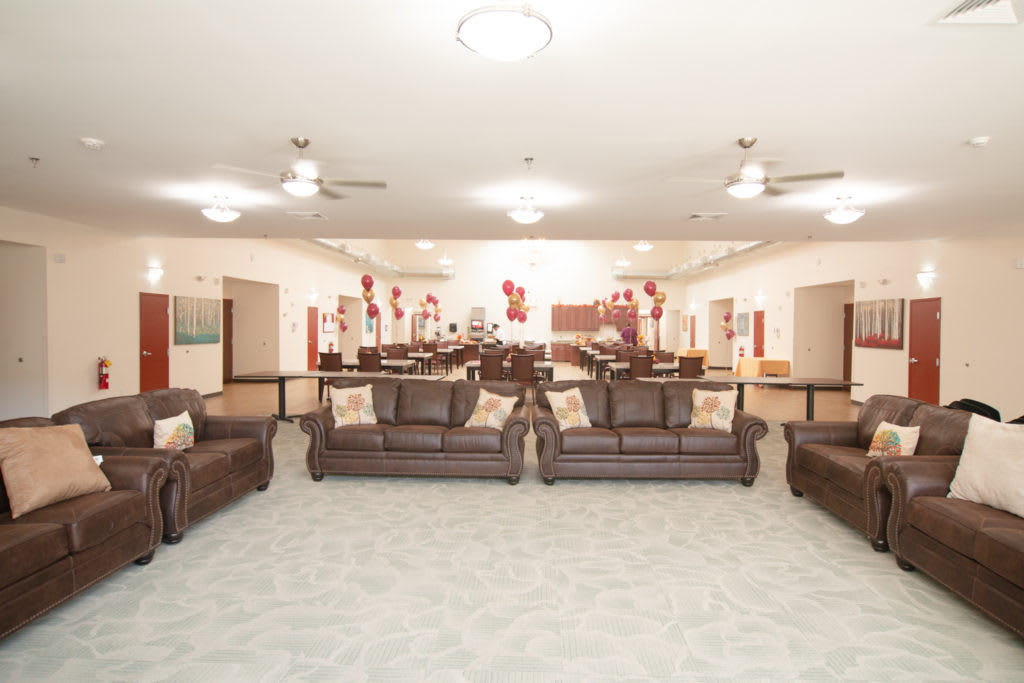 A spacious living room setup with multiple sofas and stylish decor.