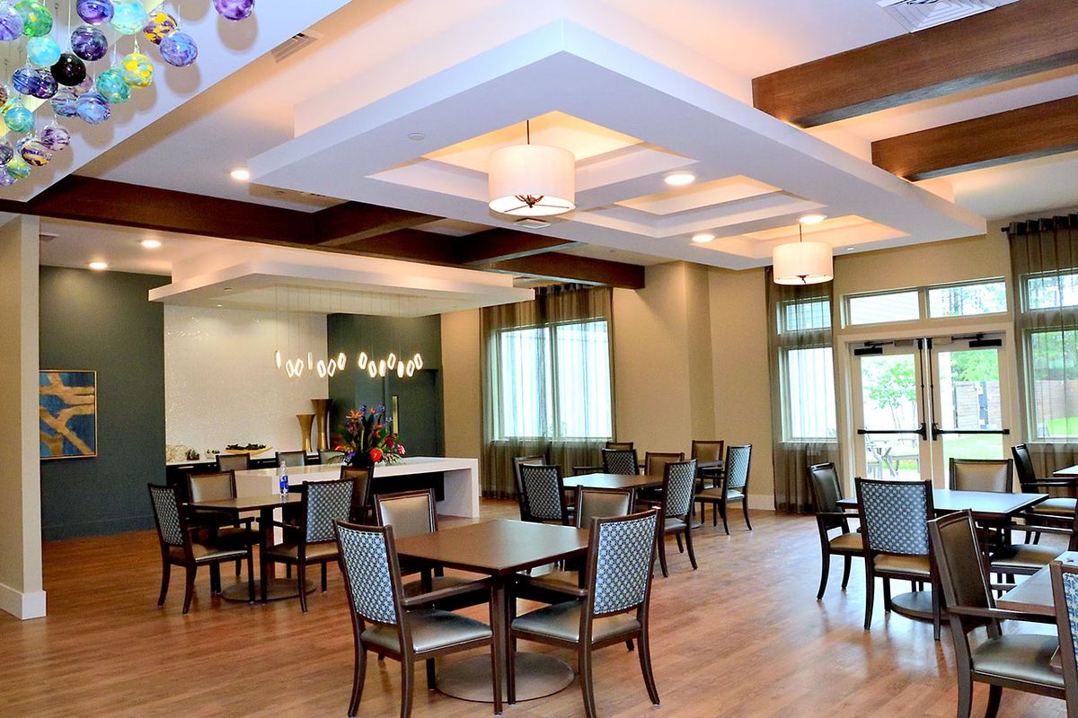 A spacious dining area with modern decor and ample natural lighting.