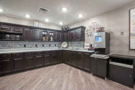 A stylish modern kitchen featuring dark cabinets, ample counter space, and contemporary appliances.