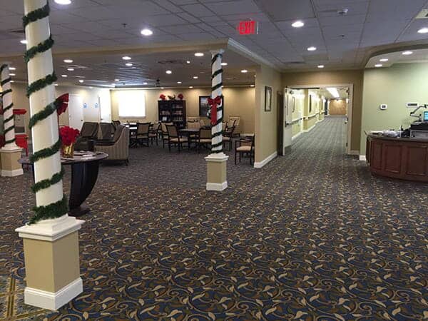 A spacious and well-lit lobby area with seating arrangements and a long hallway.