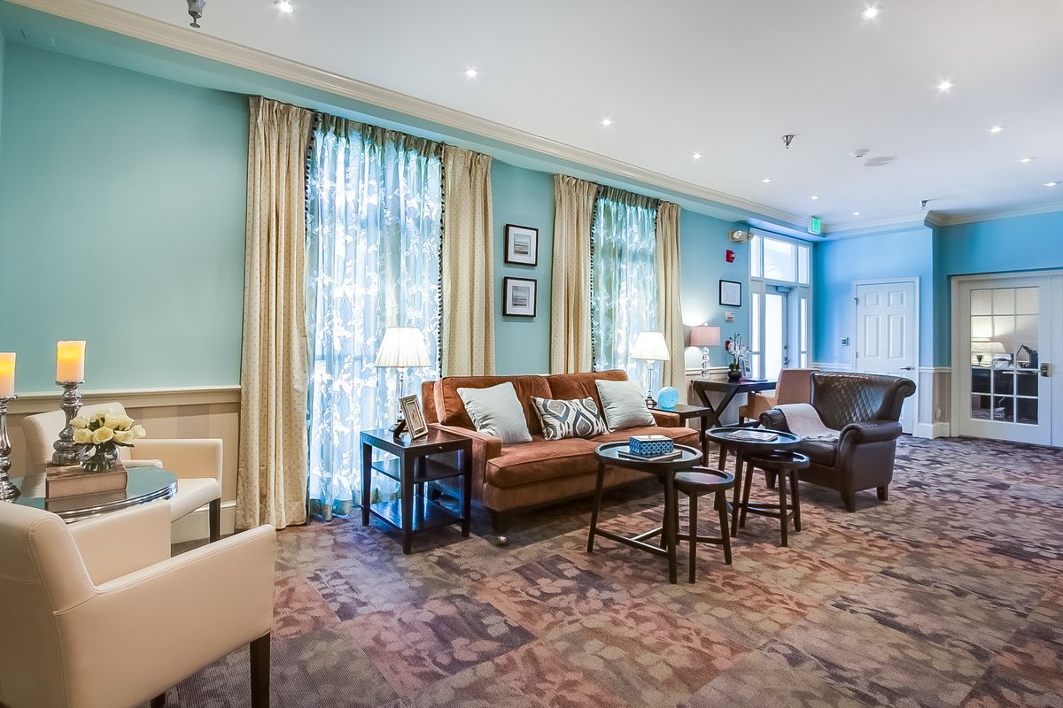 A cozy and elegantly decorated living room with comfortable seating and warm lighting.