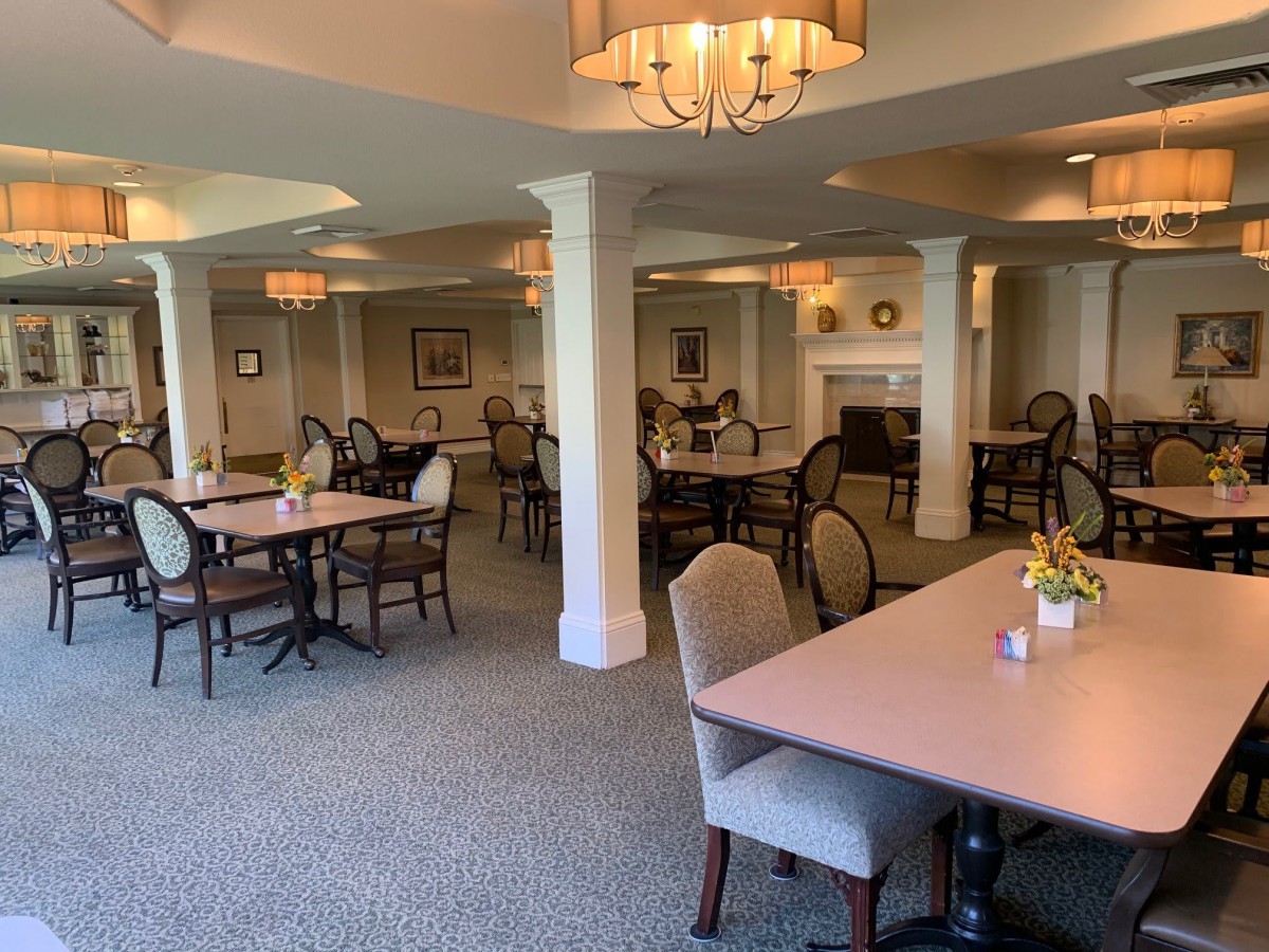 A spacious and elegantly decorated dining room with neatly arranged tables and chairs.