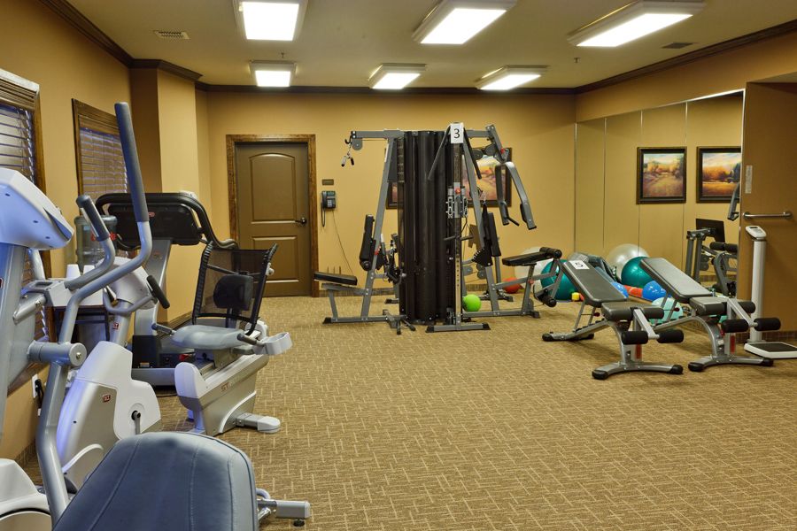 A well-equipped gym with various fitness machines and weights.