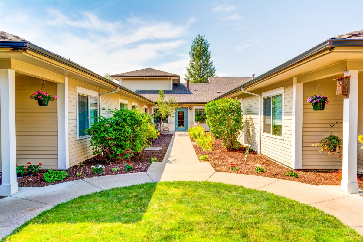 A beautiful residential house with a landscaped garden and pathway.