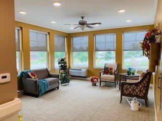 Bright and cozy living room with large windows and comfortable seating.