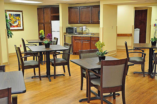 A cozy kitchen and dining area with wooden furniture and modern appliances.