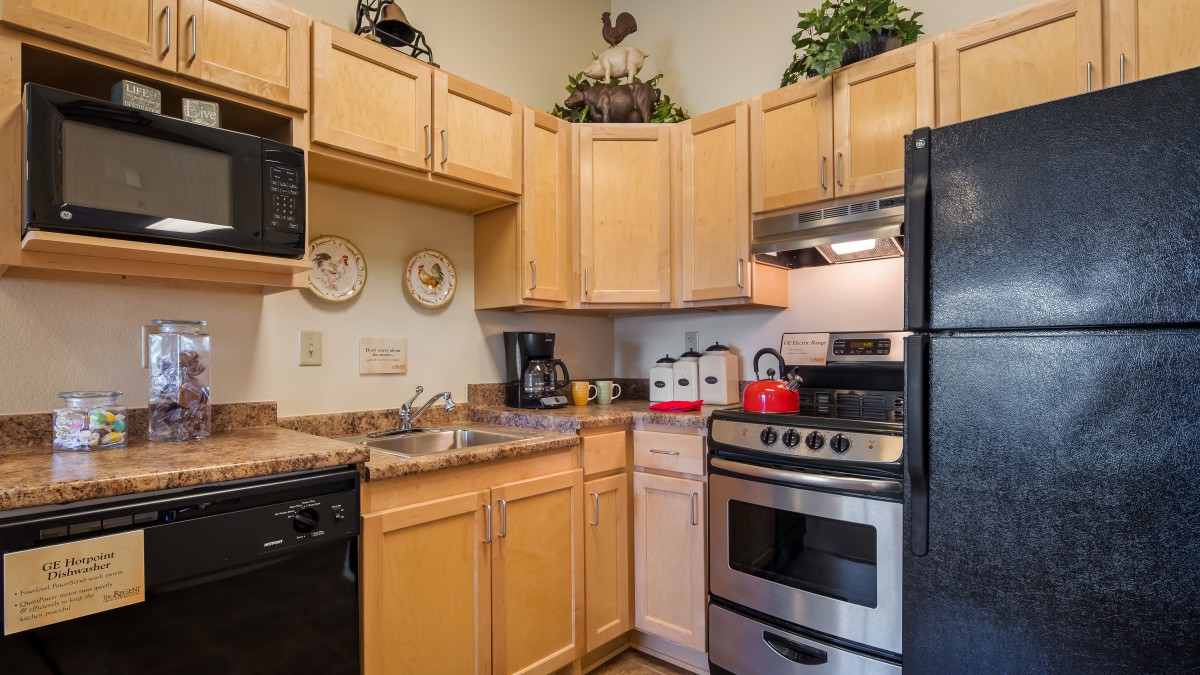 A cozy kitchen with wooden cabinets and stainless steel appliances.