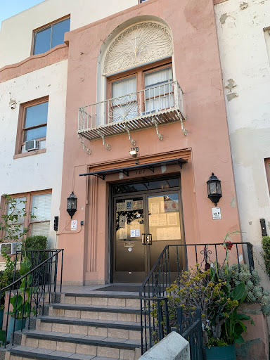 A charming residential building entrance with a decorated facade and balcony.