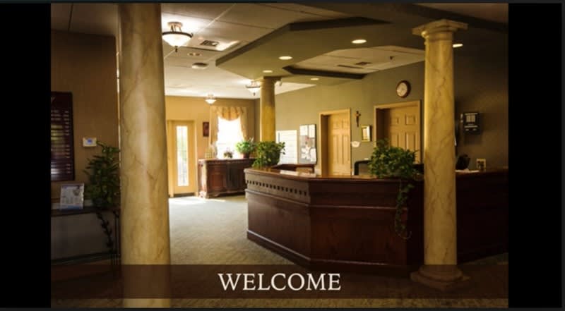 A welcoming reception area with a central desk and warm lighting.